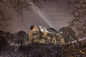 Picture of the Imperial Castle through winterly trees with the words Merry Christmas and a happy New Year in the sky