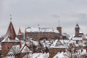 Picture of the snow covered Imperial Castle of Nuremberg with parts of the snow covered old town in the foreground