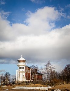A lighthouse with clouds in the background