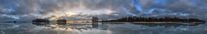 Panorama of a frozen lake with a cloudy sky during the blue hour